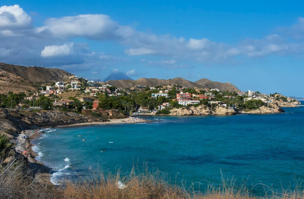 beautiful beach near a village under blue sky